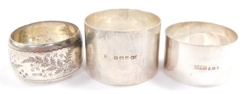 A Victorian silver napkin ring, engraved with ferns, London 1887, a George V silver napkin ring, monogram engraved, London 1925, and a napkin ring named to Derek Gordon, Birmingham 1921, 2.72oz. (3)