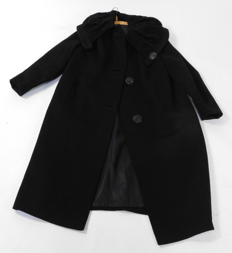 A Miracle lady's full length black coat, with an Astrakan collar.