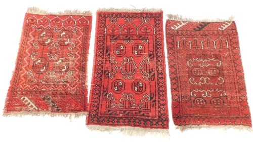 Three Caucasian prayer rugs, red ground, 109cm x 63cm, 94cm x 64cm, and 96cm x 64cm respectively.