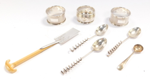 A pair of silver napkin rings, with engine turned decoration, Birmingham 1957, further napkin ring, monogram engraved, Birmingham 1901 (AF), three coffee spoons with coiled handles, salt spoon, Sheffield 1933, 2.54oz, and a Victorian silver plated trowel 