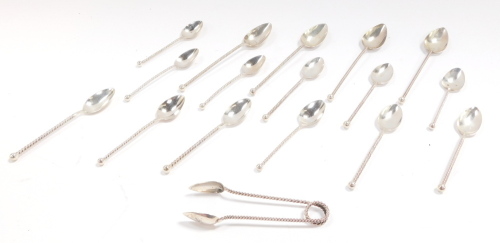 A set of twelve Dutch early 20thC silver coffee spoons, with spiral twist handles, together with a pair of sugar tongs, and four tea spoons, 5.27oz.