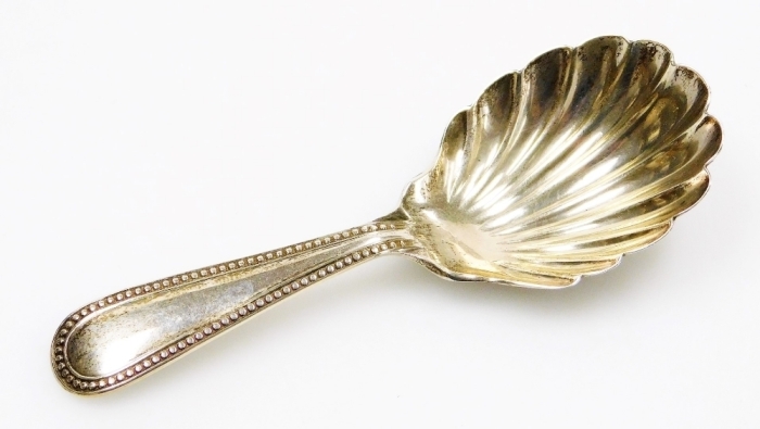 A Victorian silver caddy spoon, with a shell pattern bowl and beaded handle, Exeter 1876, 9cm long.