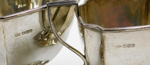 A George V silver three piece tea service, comprising teapot, two handled sugar bowl and milk jug, each with a shaped body and angular handles on a shaped pedestal base, the teapot with an ebonised knop and handle, makers marks for Stevenson and Law, Shef - 3