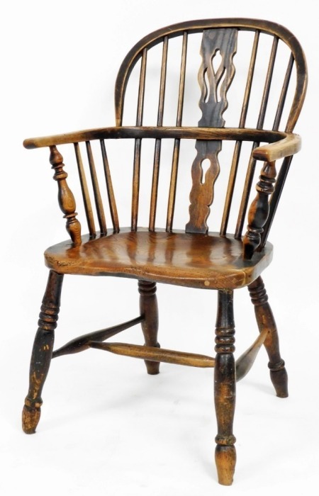 A 19thC ash and elm Windsor chair, with a pierced splat, solid seat on turned legs with H stretcher, 89cm high.