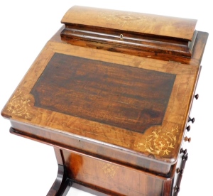 A Victorian walnut and marquetry inlaid Davenport, the hinged lid enclosing a fitted interior for pens, cards, etc., above a fall with a later hardwood inset panel enclosing a fitted interior above side drawers with turned wood handles, on a shaped platfo - 2