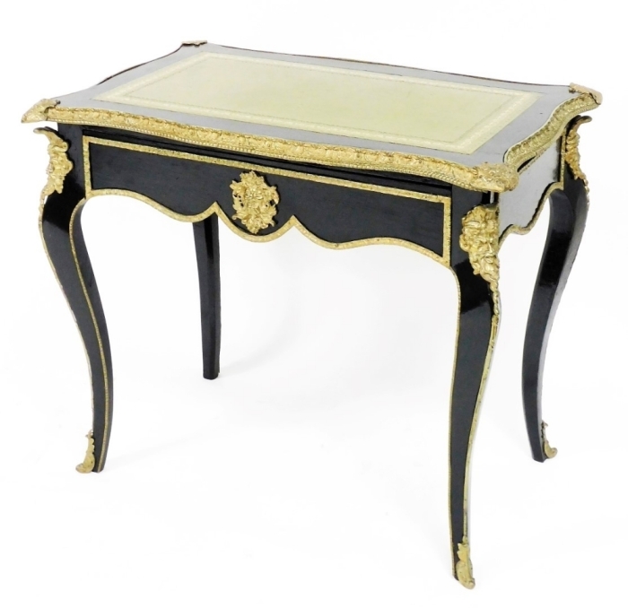 A 19thC James Winter & Son of Soho, London ebonised and ormolu mounted bureau plat in the French style, the top with a tooled leather and gilt inset panel, above a frieze drawer, on cabriole legs, 75cm high, the top 84cm x 54cm.