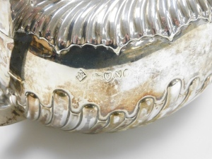 A Victorian Neoclassical design silver four piece service, with a part fluted design body and ebonised handles and knops, makers mark for RM and EH, London 1888, 33oz gross. - 2