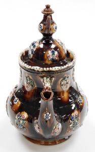 A late 19thC bargeware treacle glaze teapot, titled Mrs Burden, Basford and dated 1891, with a miniature teapot finial, the body decorated with flowers, etc., 33cm high. - 2