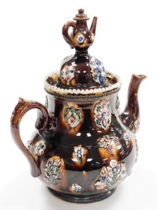 A late 19thC bargeware treacle glaze teapot, titled Mrs Burden, Basford and dated 1891, with a miniature teapot finial, the body decorated with flowers, etc., 33cm high. - 3