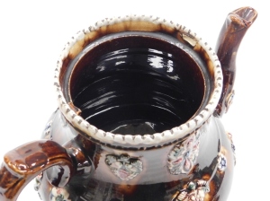 A late 19thC bargeware treacle glaze teapot, titled Mrs Burden, Basford and dated 1891, with a miniature teapot finial, the body decorated with flowers, etc., 33cm high. - 4