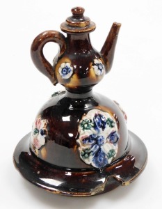 A late 19thC bargeware treacle glaze teapot, titled Mrs Burden, Basford and dated 1891, with a miniature teapot finial, the body decorated with flowers, etc., 33cm high. - 6