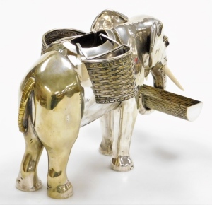 An early 20thC silver plated and glass centrepiece or posy holder, in the form of an elephant, with ivory tusks and glass eyes, the trunk holding a rectangular cylindrical vacant log shaped vessel, with a central vacant glass body with a removable section - 2