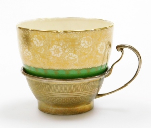 A set of four early 20thC Grosvenor China teacups and saucers, each teacup with a silver engine turned holder with marks for Birmingham 1921, in a fitted case. - 4