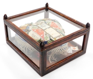 A Devonshire Regiment forget me not heart shaped sweetheart pin cushion, with various beaded detailing and Devonshire Regiment central shield, in a stained oak case, 19cm high, 30cm wide, 34cm deep.