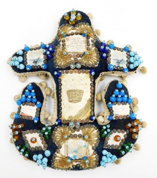 A Hands Across the World naval anchor beaded sweetheart pin cushion, with blue overall design and various applied picture panels and central plaque, with outer cream pom pom detailing, 27cm high, 25cm wide.