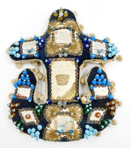 A Hands Across the World naval anchor beaded sweetheart pin cushion, with blue overall design and various applied picture panels and central plaque, with outer cream pom pom detailing, 27cm high, 25cm wide.