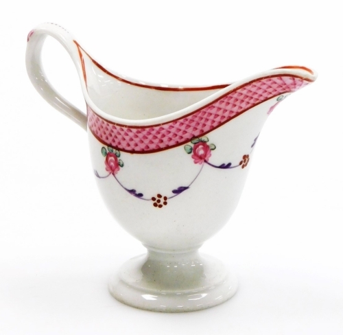 A late 18thC Newhall porcelain helmet shaped cream jug, pattern number 67, with scale border and rose swag design, circa 1780, 10cm high.