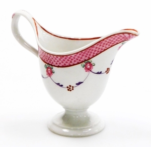 A late 18thC Newhall porcelain helmet shaped cream jug, pattern number 67, with scale border and rose swag design, circa 1780, 10cm high.
