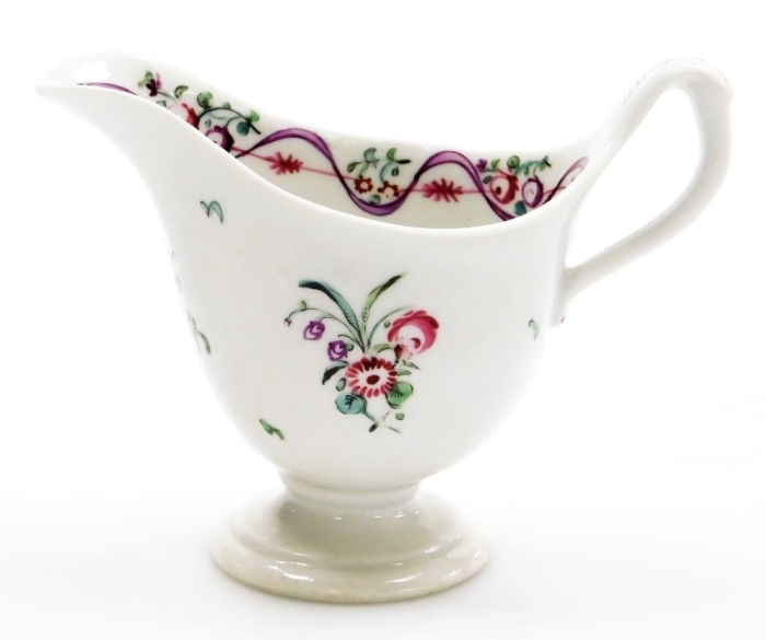 A late 18thC Newhall porcelain helmet shaped cream jug, pattern number 172, with rose spray decoration, 9cm high.