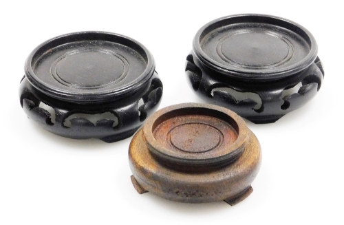 Three hardwood stands, a pair of black ebonised stands, 6.5cm wide, and a brown Oriental stand, 5.5cm wide. (3)