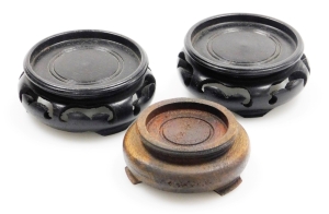 Three hardwood stands, a pair of black ebonised stands, 6.5cm wide, and a brown Oriental stand, 5.5cm wide. (3)