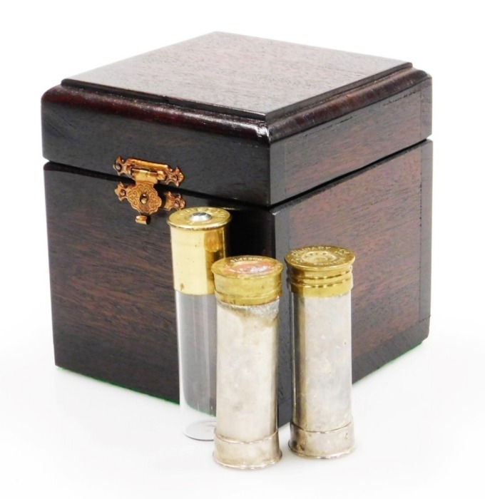 A group of nine novelty Ely shotgun cartridges, converted to storage bottles with plastic tops, in fitted case, together with an additional cheddite shell cased bottle and a pair of Culinary Concepts salt and pepper pots.