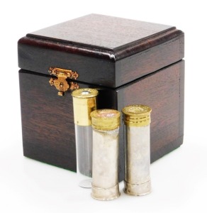 A group of nine novelty Ely shotgun cartridges, converted to storage bottles with plastic tops, in fitted case, together with an additional cheddite shell cased bottle and a pair of Culinary Concepts salt and pepper pots.