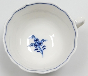 A Meissen Onion pattern trio, comprising a blue and white cup and saucer, each with floral scrolled patterning and blue cross sword mark to underside, together with a matching plate. (3) - 3