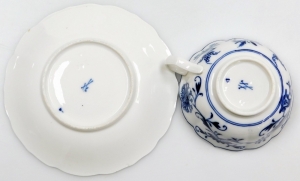 A Meissen Onion pattern trio, comprising a blue and white cup and saucer, each with floral scrolled patterning and blue cross sword mark to underside, together with a matching plate. (3) - 4