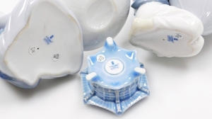 Three Lladro porcelain ornaments, comprising a Lladro figure of a seated monk with bowl, 14cm high, a figure of a kneeling monk carrying bowl, 15cm high, and a candle stand, 4cm high. (3) - 3