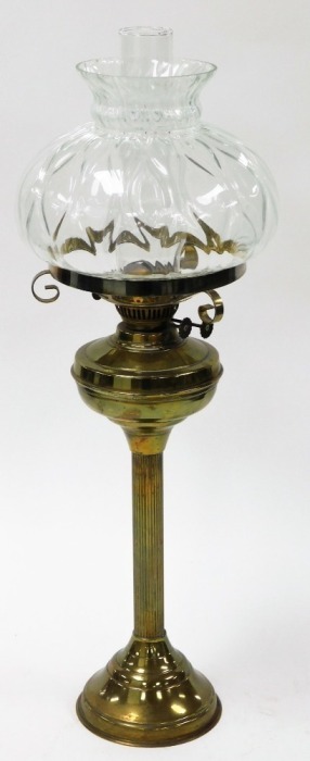 A Victorian style brass oil lamp, with large dome glass top and flute, on reeded column and a stepped base, 72cm high.