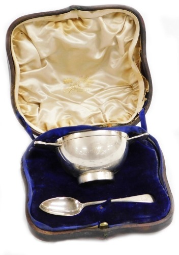 An Edwardian silver loving cup in Celtic style, the inscribed bowl presented to George Anthony Ratcliff Fillingham from his loving Godmother Lady Blake, with presentation gift card, bearing the initials GARF, Chester 1909, with a later matched spoon, Lond