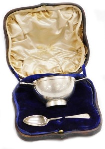 An Edwardian silver loving cup in Celtic style, the inscribed bowl presented to George Anthony Ratcliff Fillingham from his loving Godmother Lady Blake, with presentation gift card, bearing the initials GARF, Chester 1909, with a later matched spoon, Lond