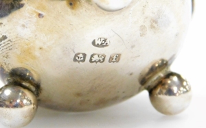 A 19thC silver sifter spoon, with a pierced bowl and shaped handle, hallmarks rubbed, marks for London, 12cm long, and a pair of Edward VII open salts, with a flared rim on three ball feet, Birmingham 1905, and a single silver plated salt spoon (1 missing - 2