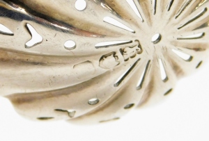 A 19thC silver sifter spoon, with a pierced bowl and shaped handle, hallmarks rubbed, marks for London, 12cm long, and a pair of Edward VII open salts, with a flared rim on three ball feet, Birmingham 1905, and a single silver plated salt spoon (1 missing - 3