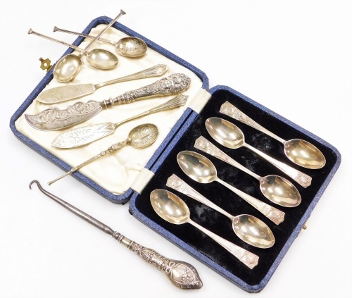 A collection of small silver, to include a set of six George V silver commemorative teaspoons, in a fitted box, London 1935, a silver handled button hook, a silver butter knife, the blade with engraved decoration and the handle profusely decorated with a 