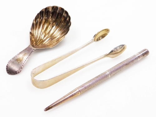 A collection of small silver, a George III silver caddy spoon, with a fluted bowl and bright cut decorated handle, London 1791, 8cm long, a pair of sugar tongs, London 1904, and a silver with engine turned decoration and a vacant cartouche, Birmingham 185