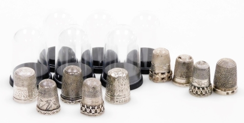 A group of nine silver thimbles, each of varying design, some in thimble cases, 2&frac12;oz.