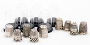 A group of nine silver thimbles, each of varying design, some in thimble cases, 2&frac12;oz.