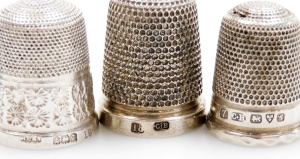 A group of nine silver thimbles, each of varying design, some in thimble cases, 2&frac12;oz. - 2