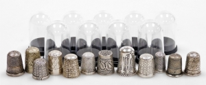A group of twelve silver thimbles, each of varying design, some in thimble cases, 3&frac12;oz.