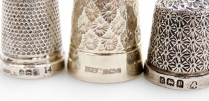 A group of twelve silver thimbles, each of varying design, some in thimble cases, 3&frac12;oz. - 3