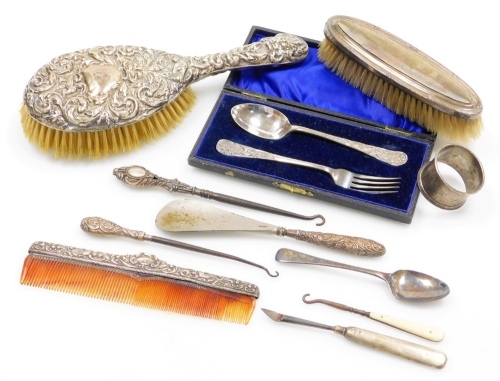 A collection of small silver and silver plated items, to include a silver plated cased christening set, silver napkin ring, Birmingham 1919, silver mounted hair brush, silver handles button hook, etc. (a quantity)
