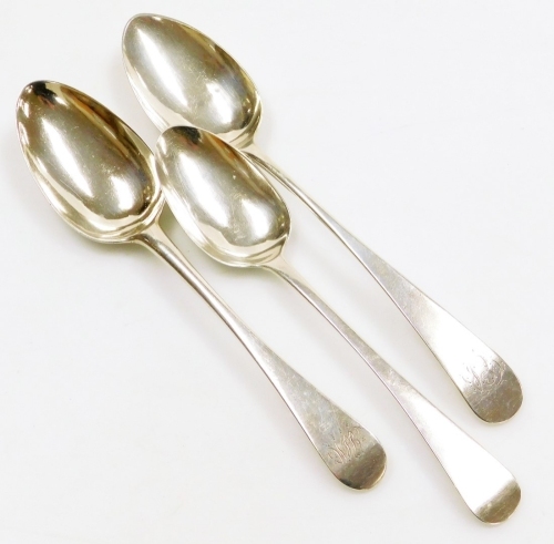 Three Georgian Old English pattern silver serving spoons, two with engraved initials, one with marks for London 1820, other hallmarks rubbed, 5&frac12;oz.