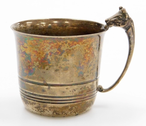 A George V silver small mug, with a cow head cast handle, the body with raised decoration, Birmingham 1913, 4&frac34;oz, 6.5cm high.