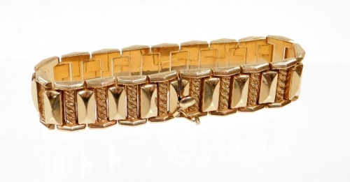 A continental style bracelet, with interwoven links and rectangular articulated supports, with slide in clasp and safety clip, yellow metal stamped 750, 20cm long, 33.3g.