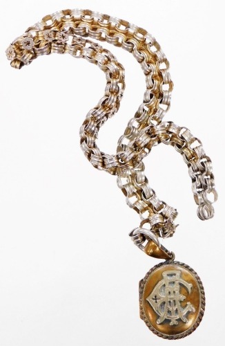 A Victorian heavy curb link neck chain, of two row design, joined by flowers, white metal, unmarked, 42cm long, together with a silver plated memorial locket, bearing initials CA, in brass overall finish, 4.5cm high, 39g all in.