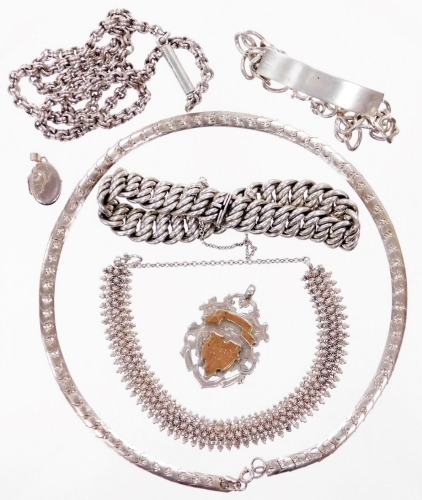 A group of silver jewellery, to include a silver curb link bracelet, 20cm long, miniature silver locket, silver shield fob inscribed F Dack from AE, a silver identity bracelet, a woven floral filigree design bracelet, white metal, unmarked, a silver artic