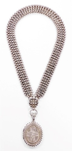 A Victorian pendant and chain, the oval pendant with leaf decoration and outer beaded detailing, white metal marked 925, 6cm high, on an elaborate three row hammered and beaded link neck chain, approx 40cm long, 81.5g all in.
