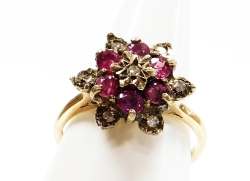 A 9ct gold dress ring, with central garnet and cz cluster, on a raised basket setting, ring size L&frac12;, 3.3g all in.